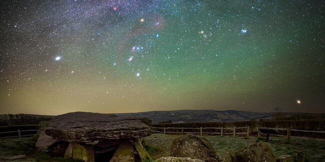 Arthurs Stone pictured at night, with a sky full of bright stars