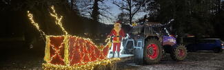 tractor and sledge lit up with fairy lights