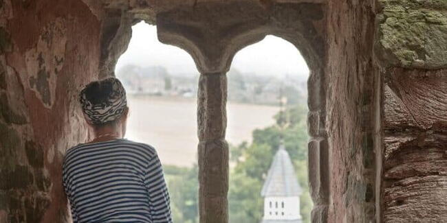 Woman looks out over hay castle during herefordshire histories festival