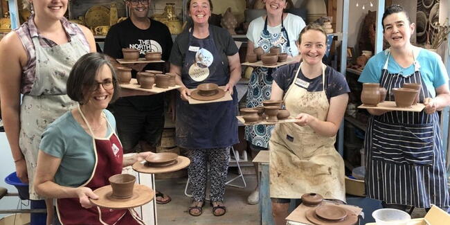 A group of people attending a pottery class at Eastnor Pottery
