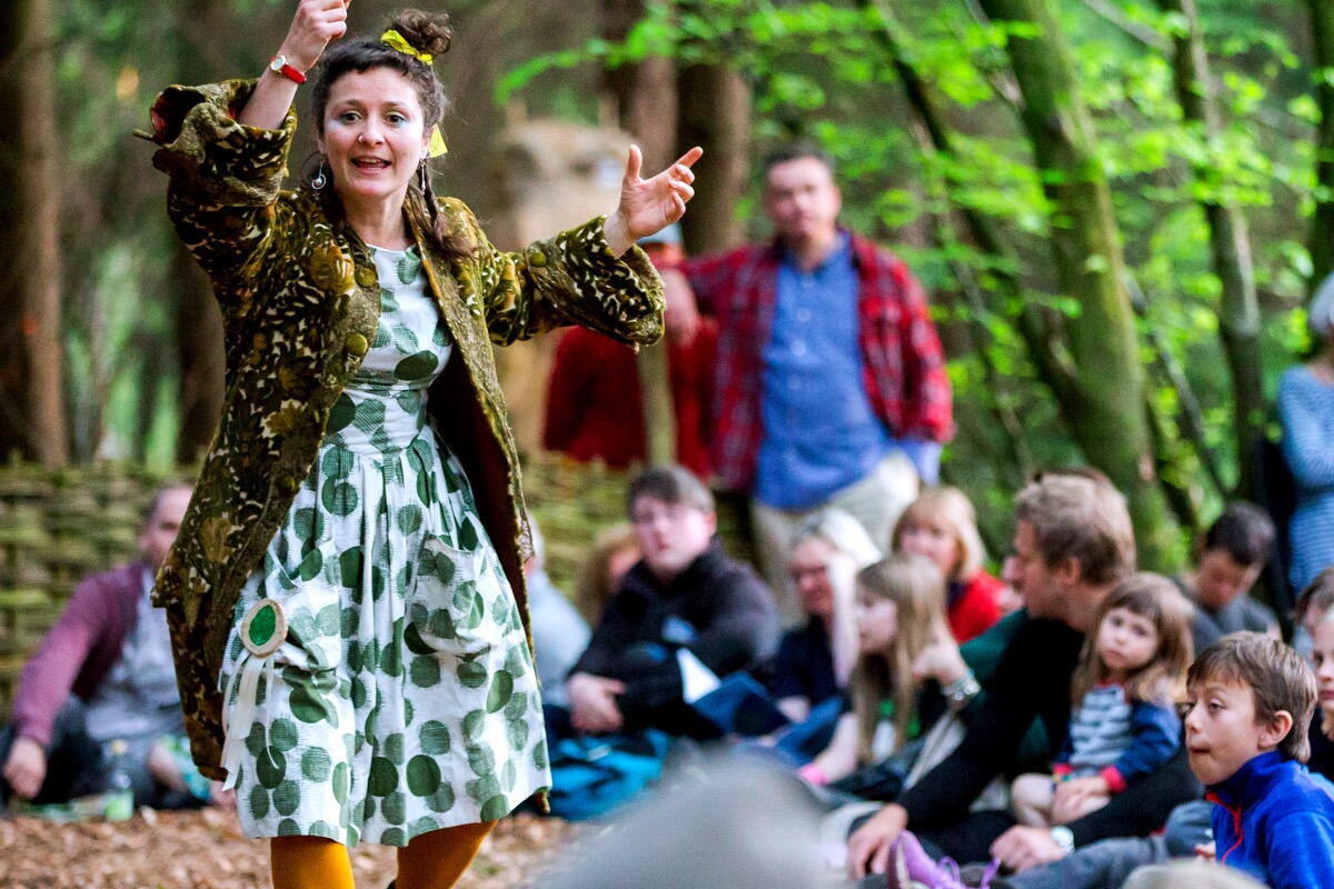 Lady passionately presents to a group in the Woods