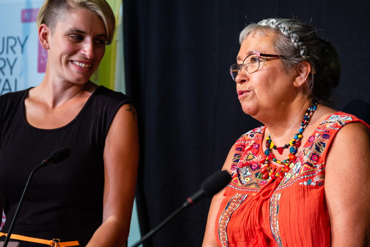 Two people on stage talking