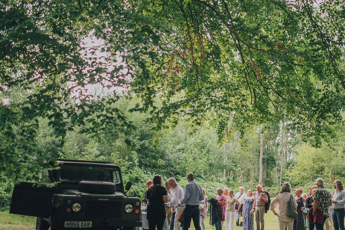 People waiting for their food in the woods