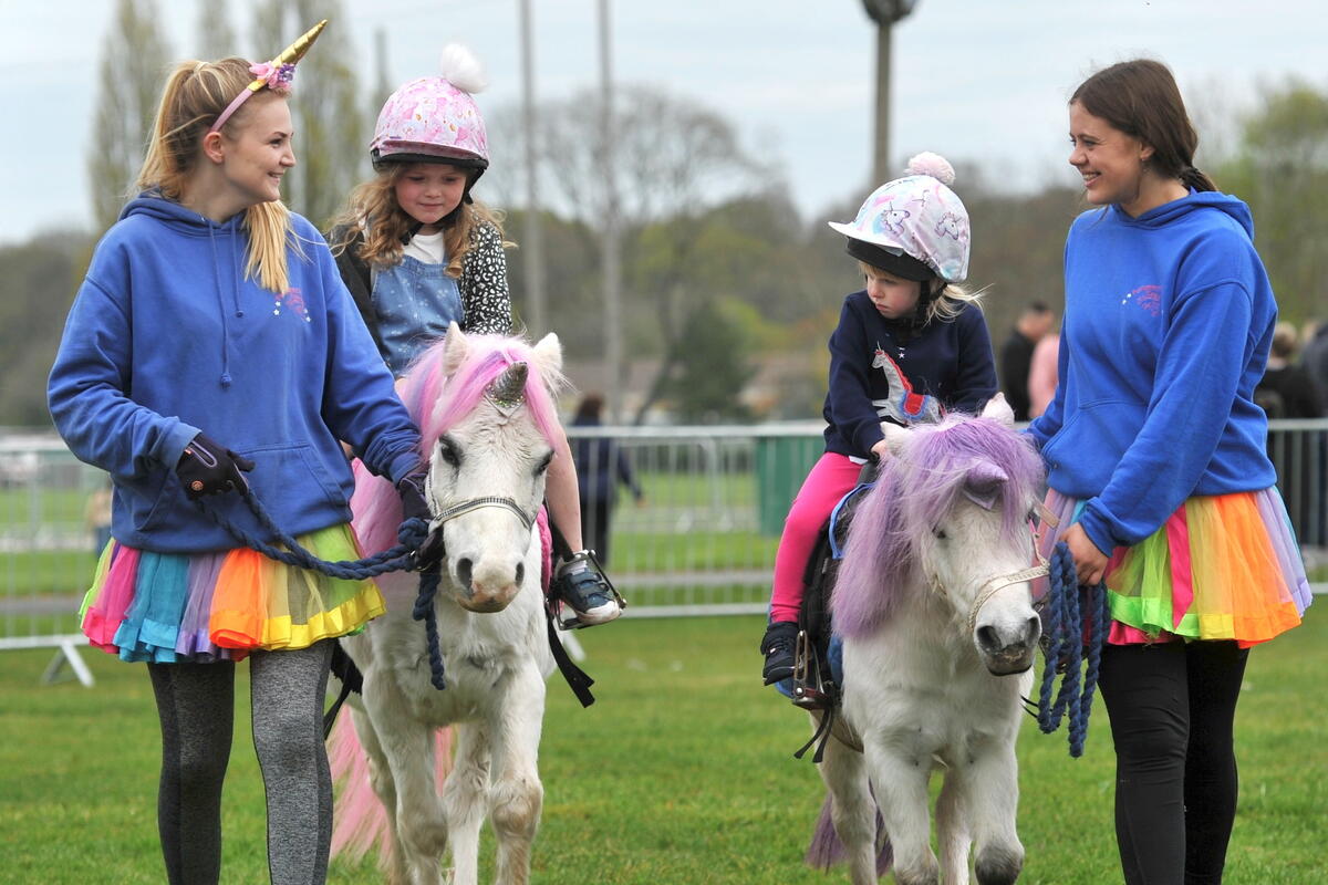 2 girls on a led pony ride