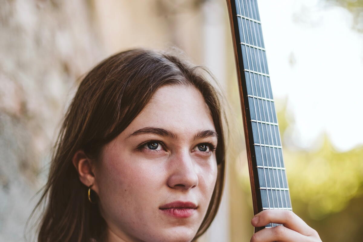 Lady holding stringed instrument