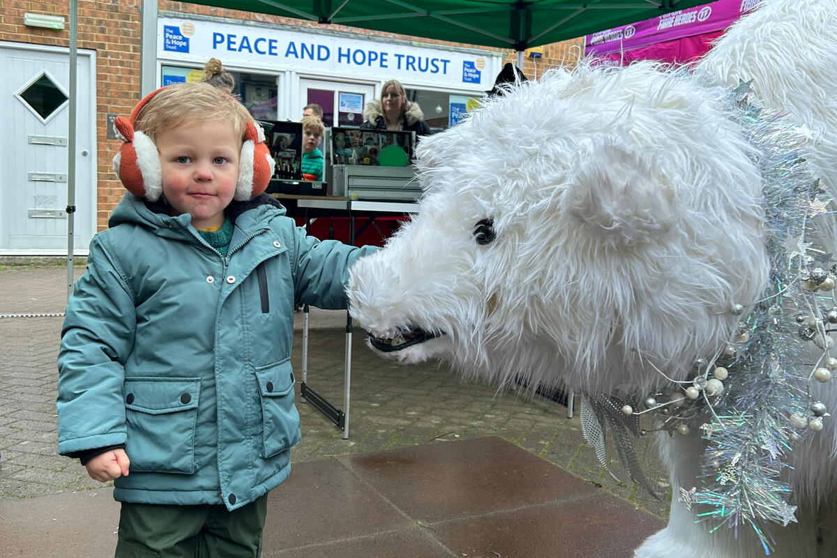 Child with polar bear sculpture