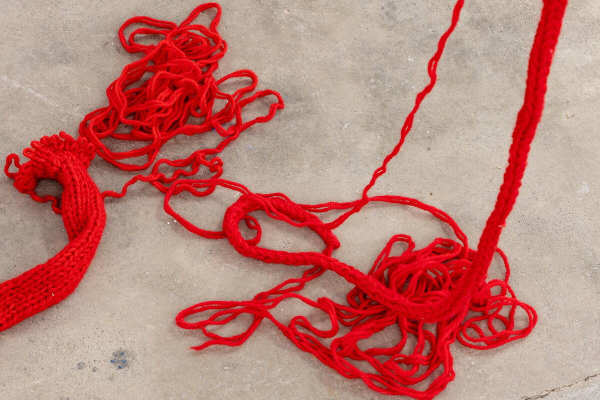 red knitted wool coming undone
