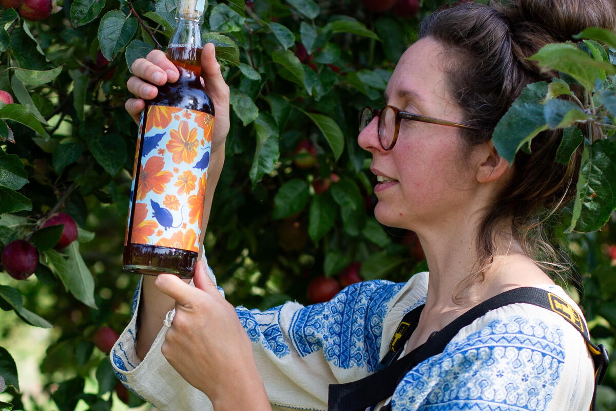 Lady holding a bottle of craft cider