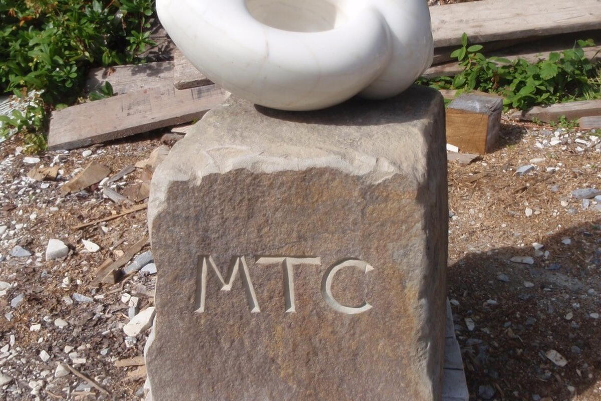 marble rounded sculpture on stone plinth