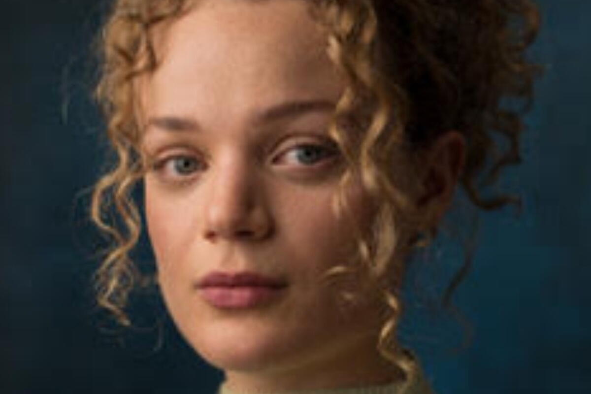 woman with pale skin and curly hair