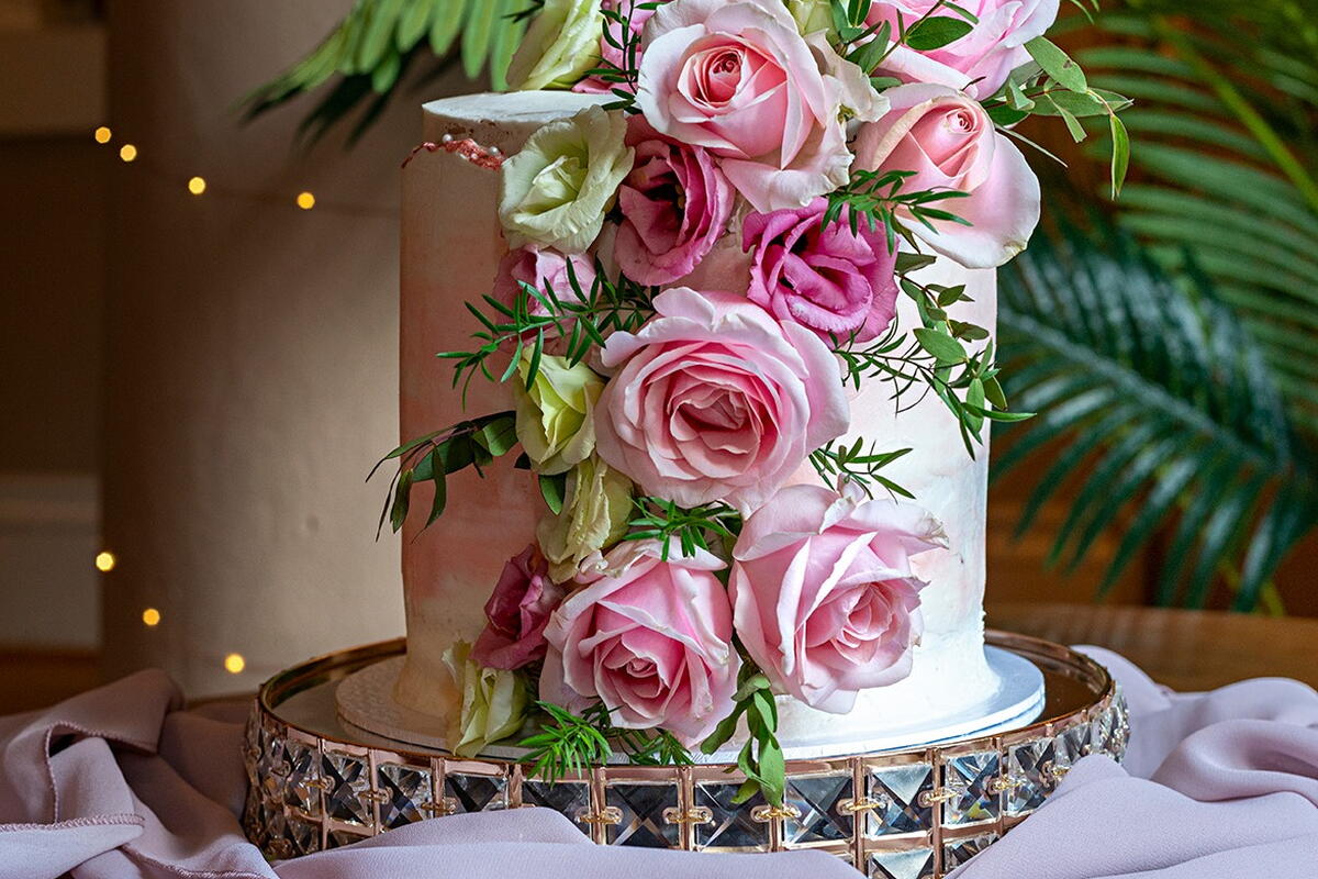 wedding cake with fresh soft pink roses