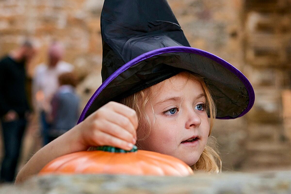 child with black pointy hat