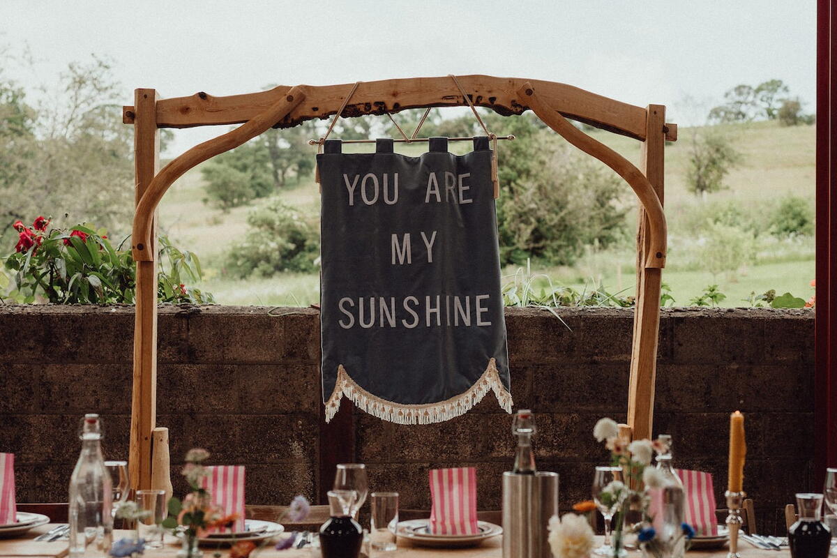 a rustic wedding sign behind the top table