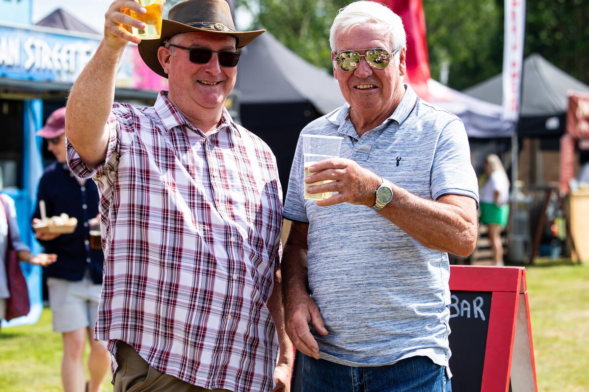 people raising glasses at a food & drink festival