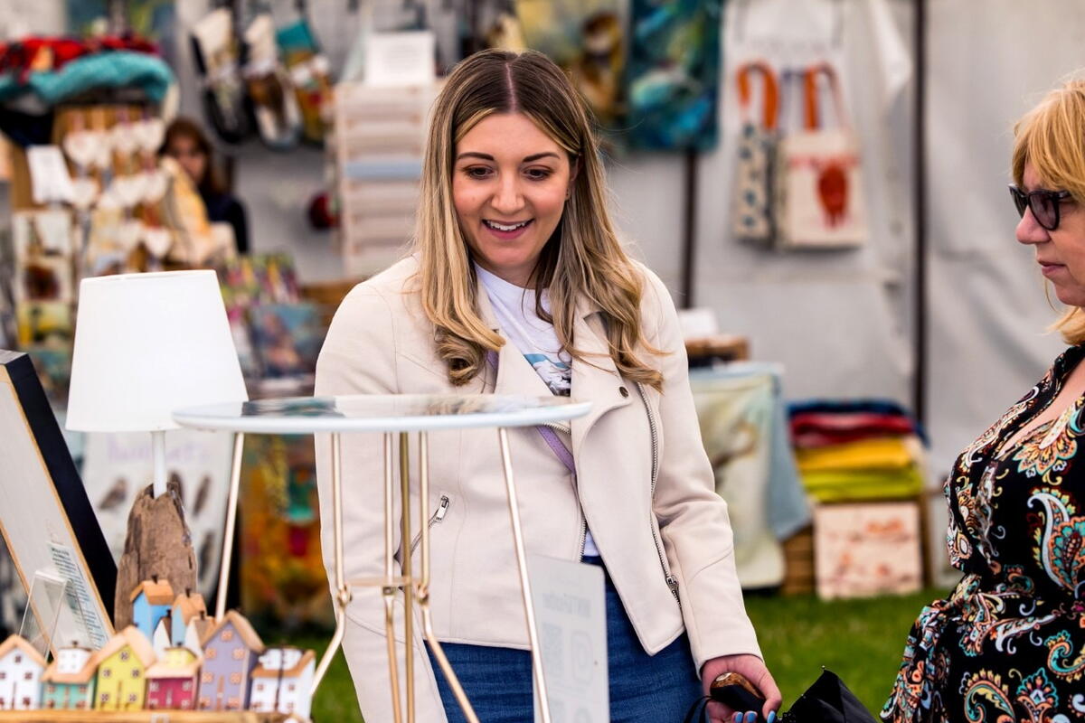 woman browsing festival craft stall