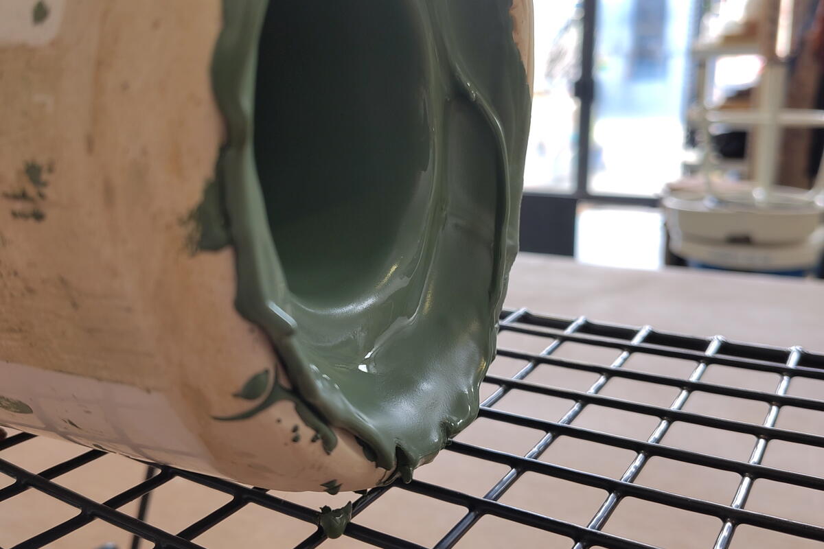 Clay slip pot drying on its side