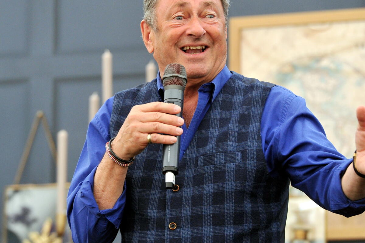 Alan Titchmarsh holding a microphone