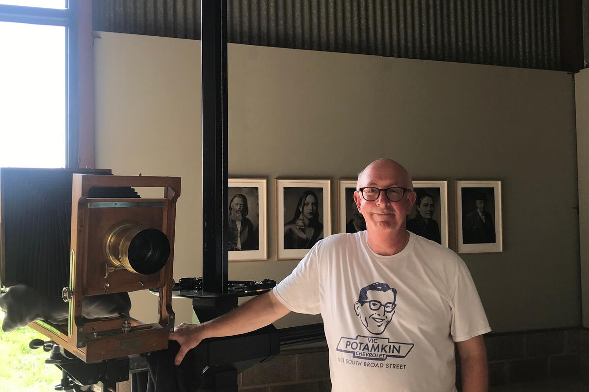 man stood with old fashioned camera