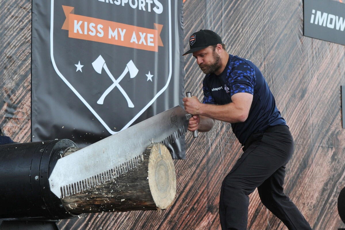 man sawing giant log
