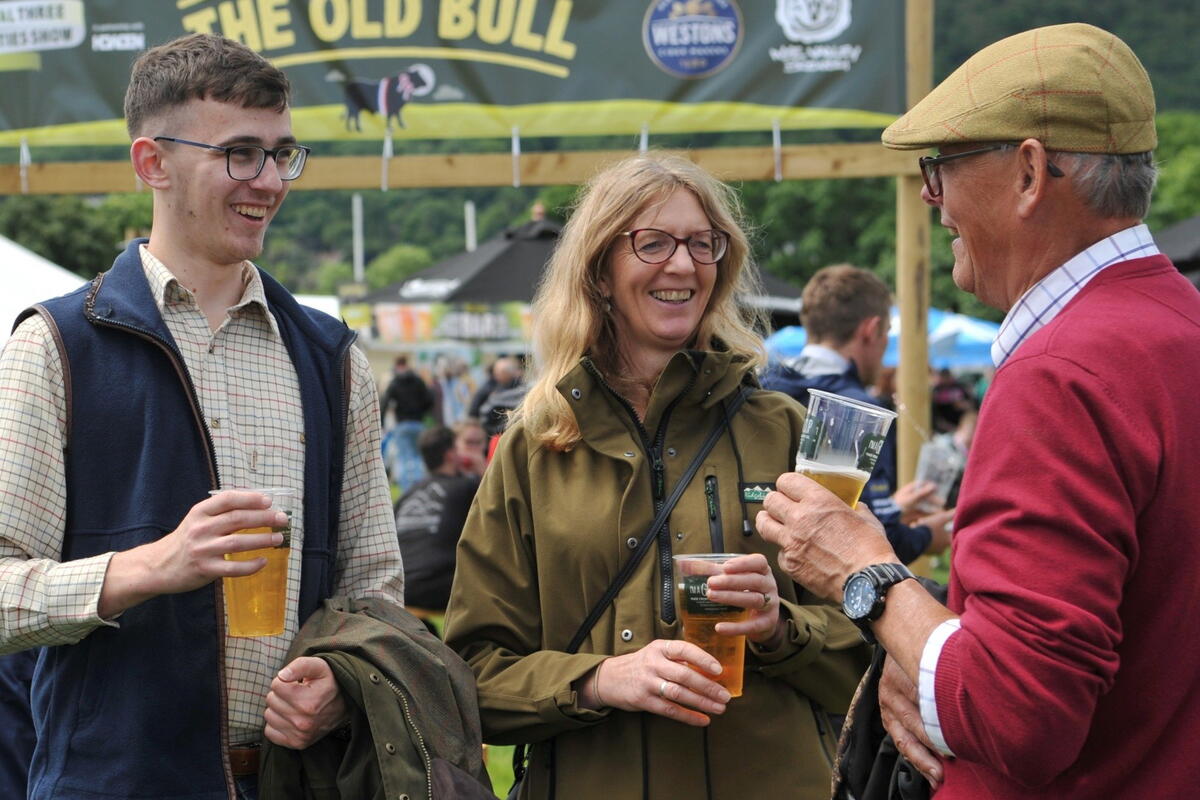 people chatting and drinking cider