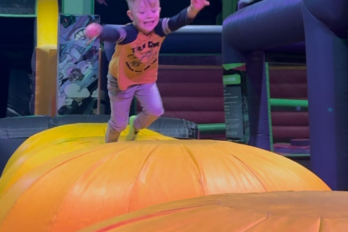 Child on an inflatable indoor assault course