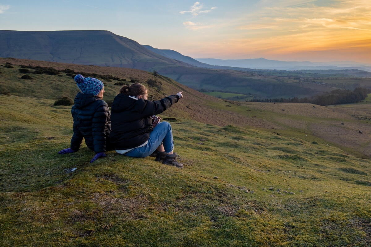 walkers looking at view sat down on Hay Bluff mountain