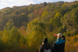 Two walkers look out over the river