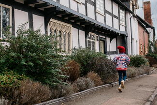 Child skipping past The Throne, Weobley