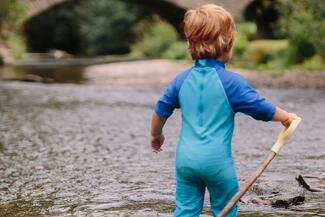 Child paddling in the river