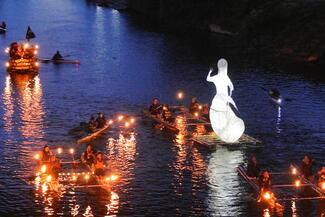 Illuminated floats on the river wye at night