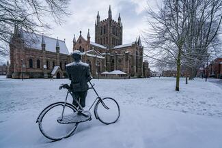 Hereford Cathedral in snow with Edward Elgar statue in foreground