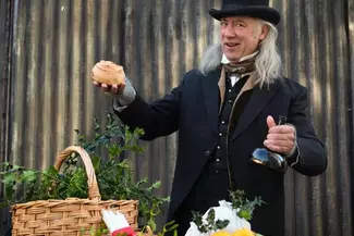 Victorian style dressed man with hamper