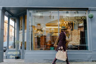 Woman walking past antique shop