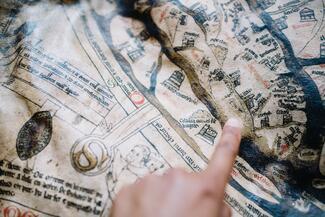 pointing to one of the world's oldest maps