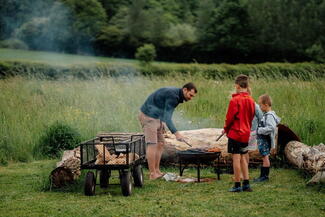 Family gathered near a firepit