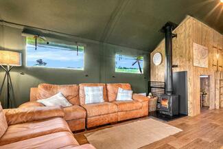 cosy cabin interior with leather sofas and stove