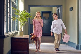 Two children checking in to Green Dragon hotel