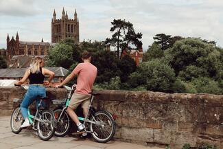 couple on bikes on old bridge in Hereford