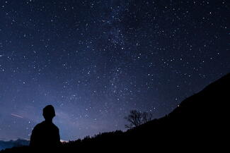 silhouette of person walking at night