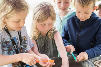 Children taking place at an archeological dig