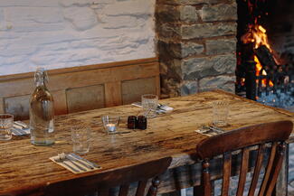 Fireside table set for dinner in country pub