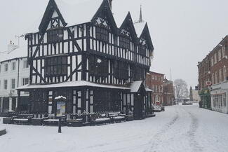 Tudor timber framed building in the snow