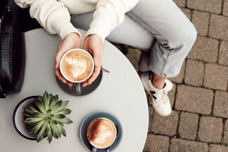 Hands around a cup of coffee