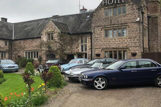 Tudor hotel with cars parked outside the front
