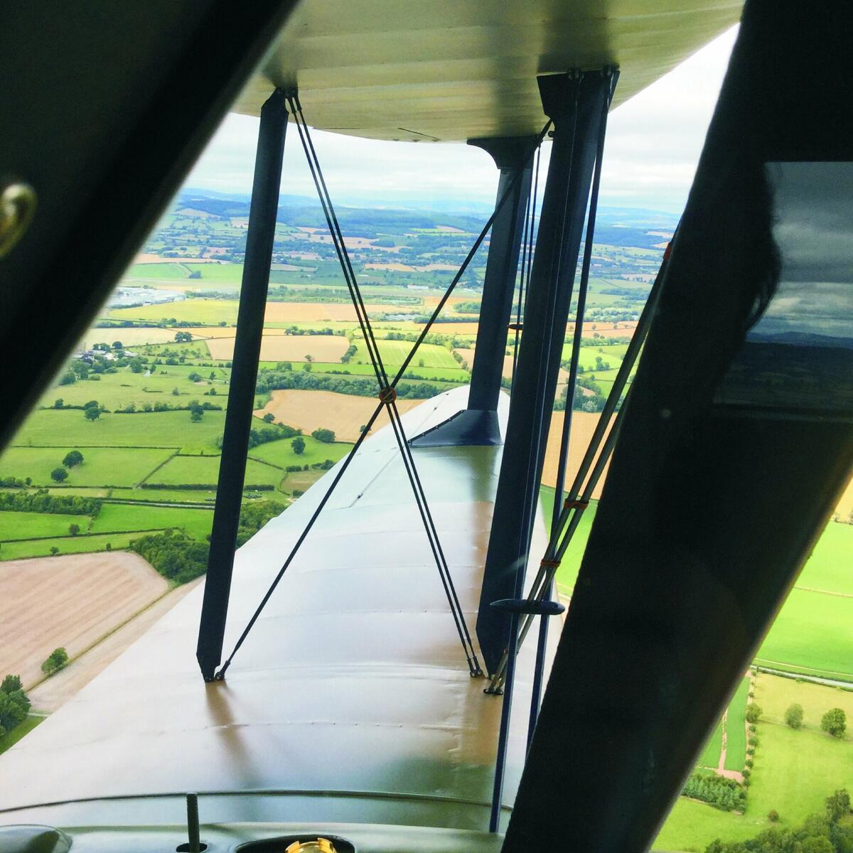 View of the airfield through the wing of a DH Dragon Rapide