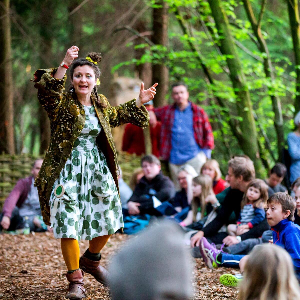 Lady passionately presents to a group in the Woods