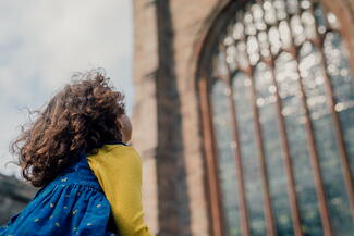 young girl looking up at cathedral