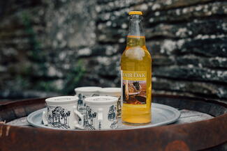 Bottle of Cider with mugs