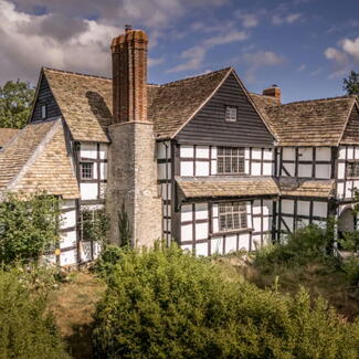 black and white tudor era farm house