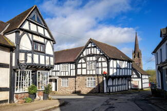 black and white village with church spire in the background